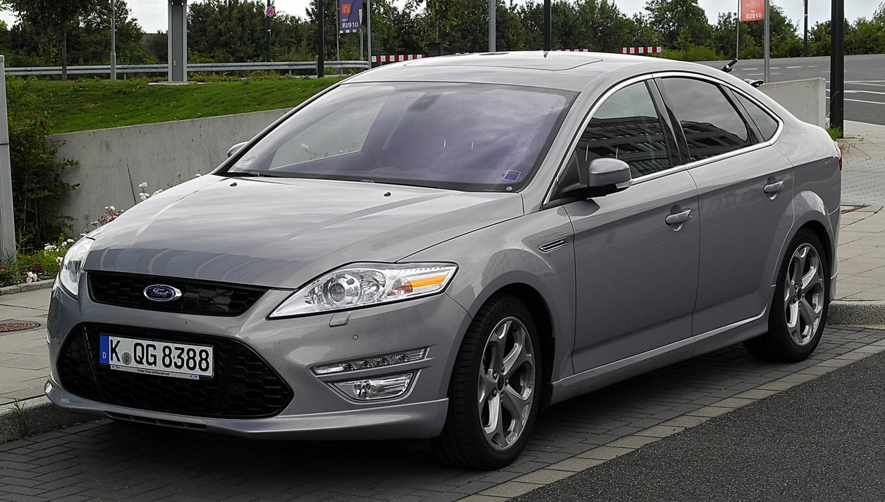 A 2011-ish (post-facelift) Ford Mondeo, in silver, which still looks like a modern car.