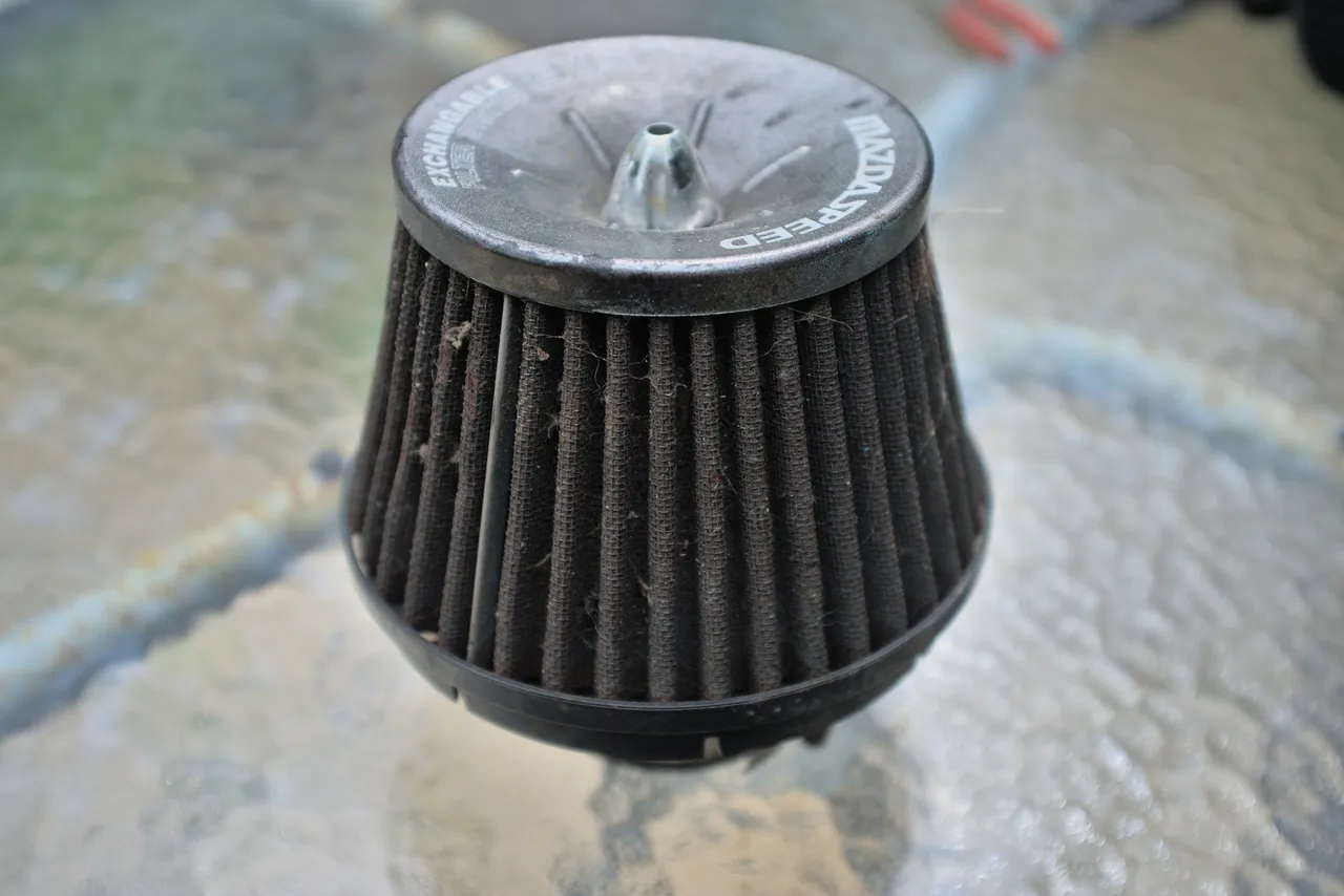 A generic 3-inch air filter, marked with MAZDASPEED EXCHANGEABLE FILTER SYSTEM EXS.