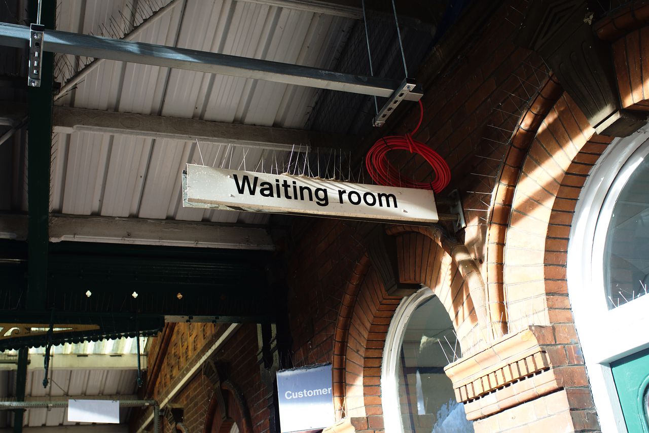 A sign for a waiting room, also simple black on white