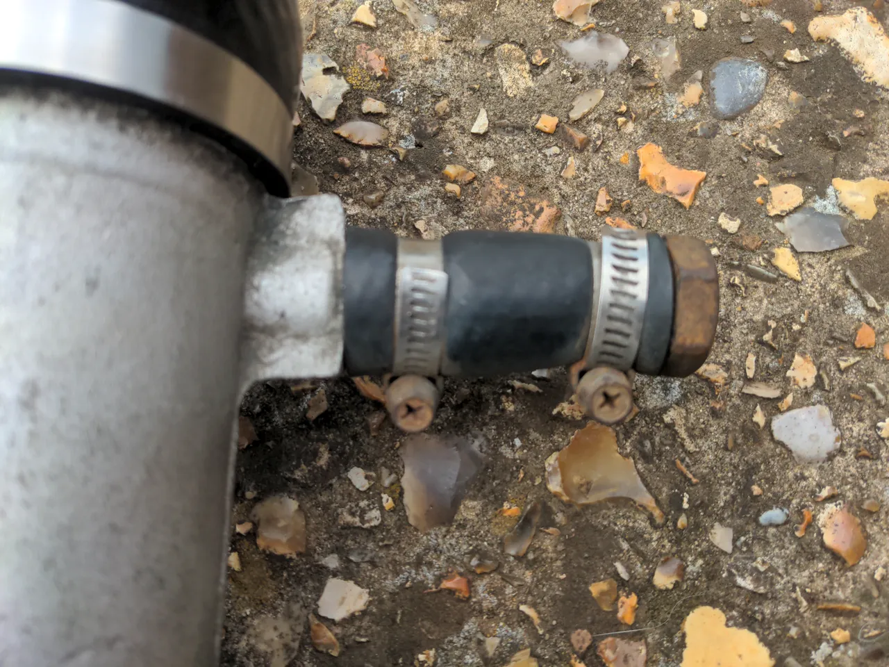 A stub of pipe blanked off by clamping a hose over it, then clamping a bolt into the other end