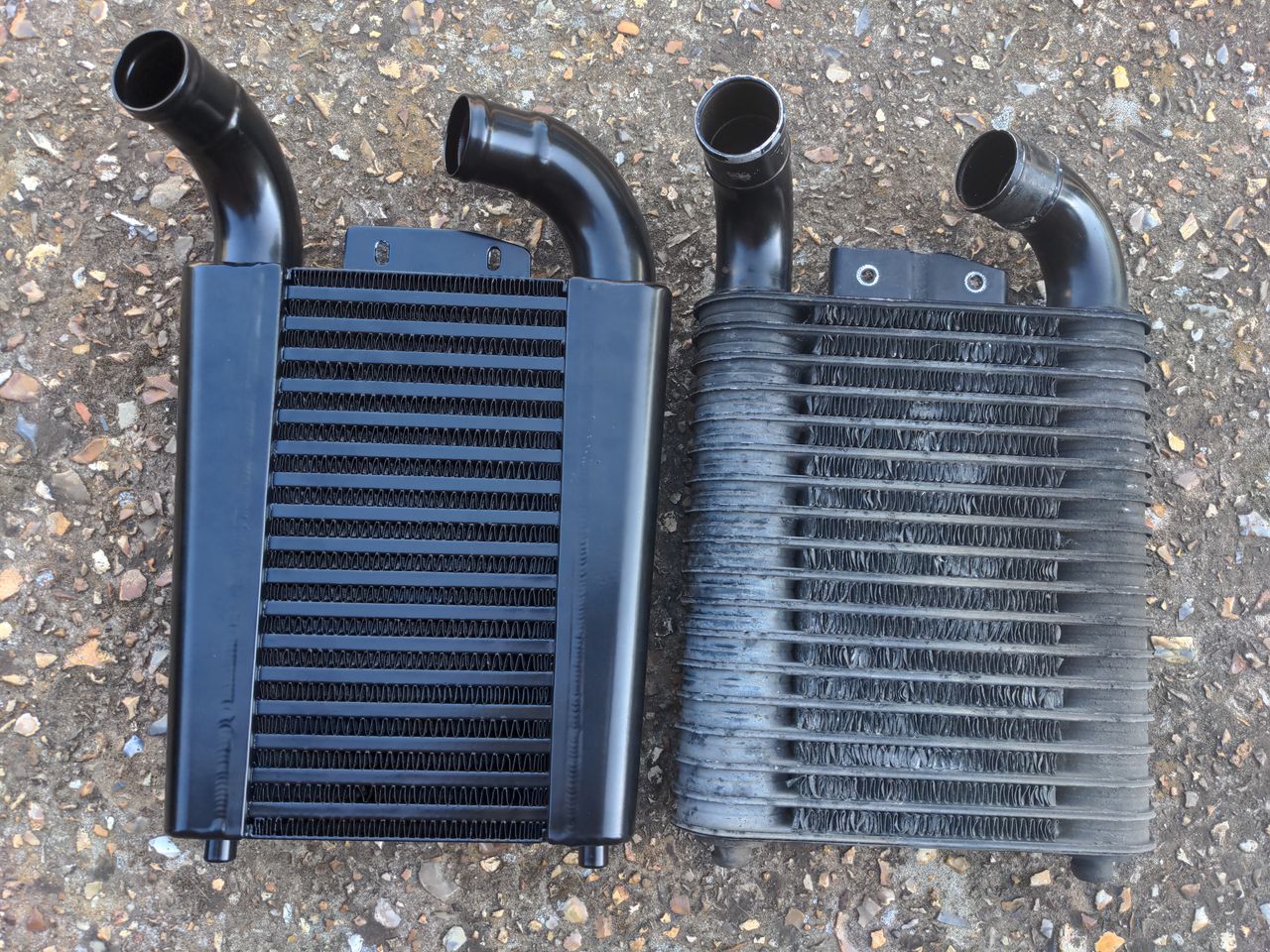 Pro Alloy 323 GTX intercooler vs the stock unit. The Pro Alloy unit is very obviously a more capable unit which can flow more. The old one has many bent fins.