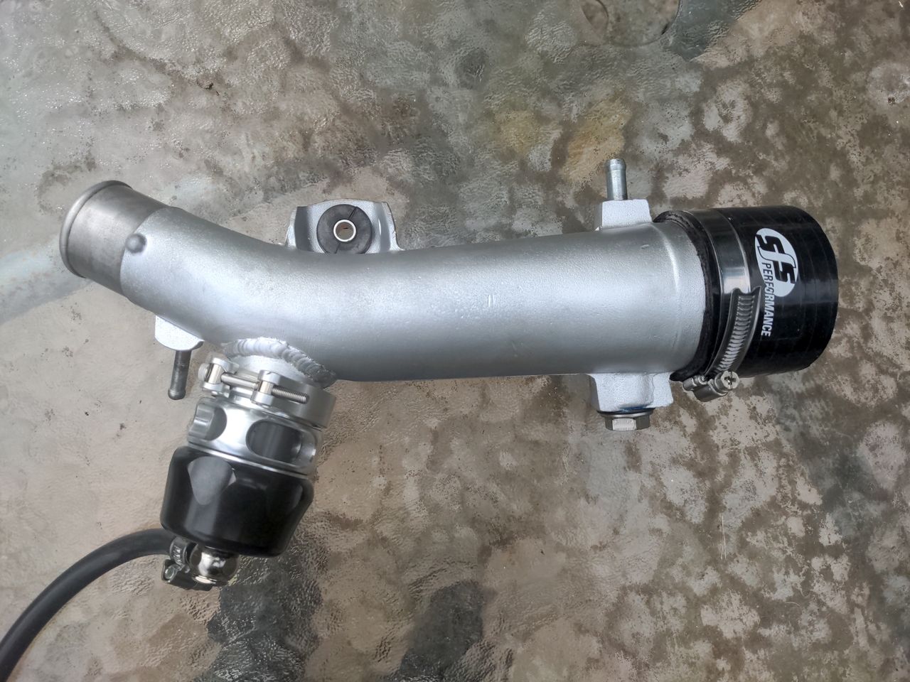 My finished intake pipe, with black Turbosmart BOV attached, the new coupling hose attached, and a coat of silver paint.