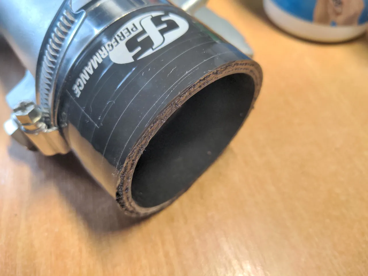 My new coupling hose with a semi-neat cut, and the white polyester strands on the inside drawn over with black permanent ink.