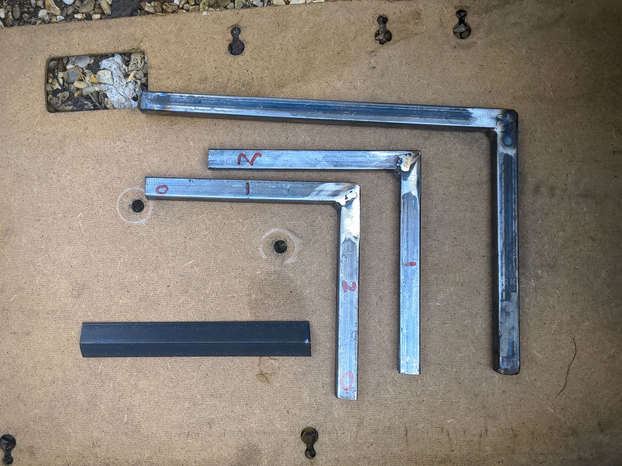 Three pieces of steel: box section cut and welded into right-angles and a small length of angle iron