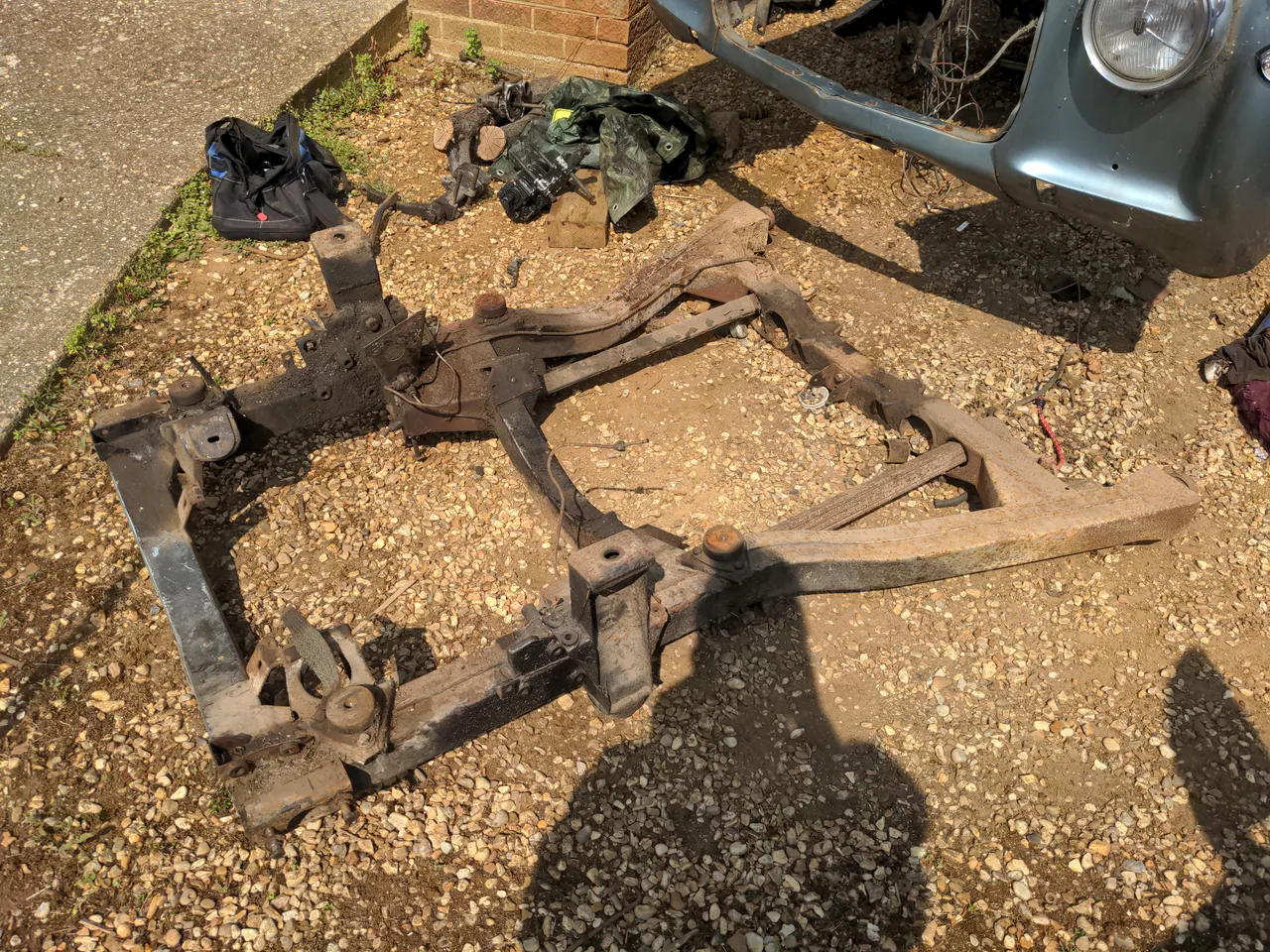 The front subframe of a Rover P5. It somewhat resembles half of a ladder chassis. This is what the engine, gearbox, and all the front suspension components bolt to. This bolts onto the underside of the front of the car.