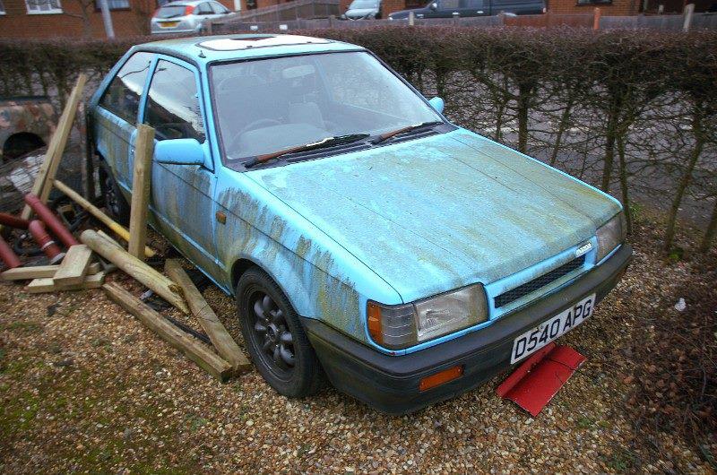 The Mazda, during her 8-year idle period, rotten and covered in mould.