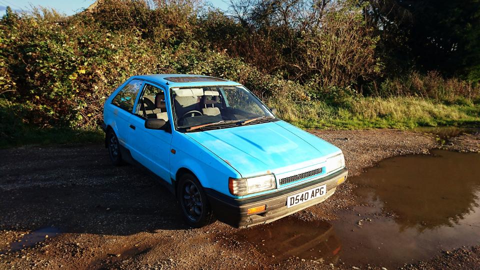 Mazda 323 GTX in a muddy car park