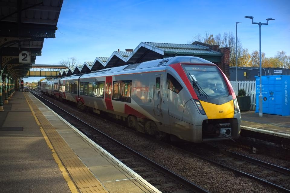 A British Rail class 755 unit at March station, under a blue sky.