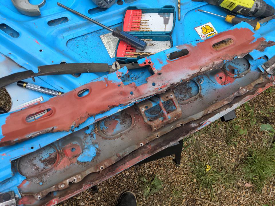 A large section has been cut out of the front lip of the bonnet near to the 