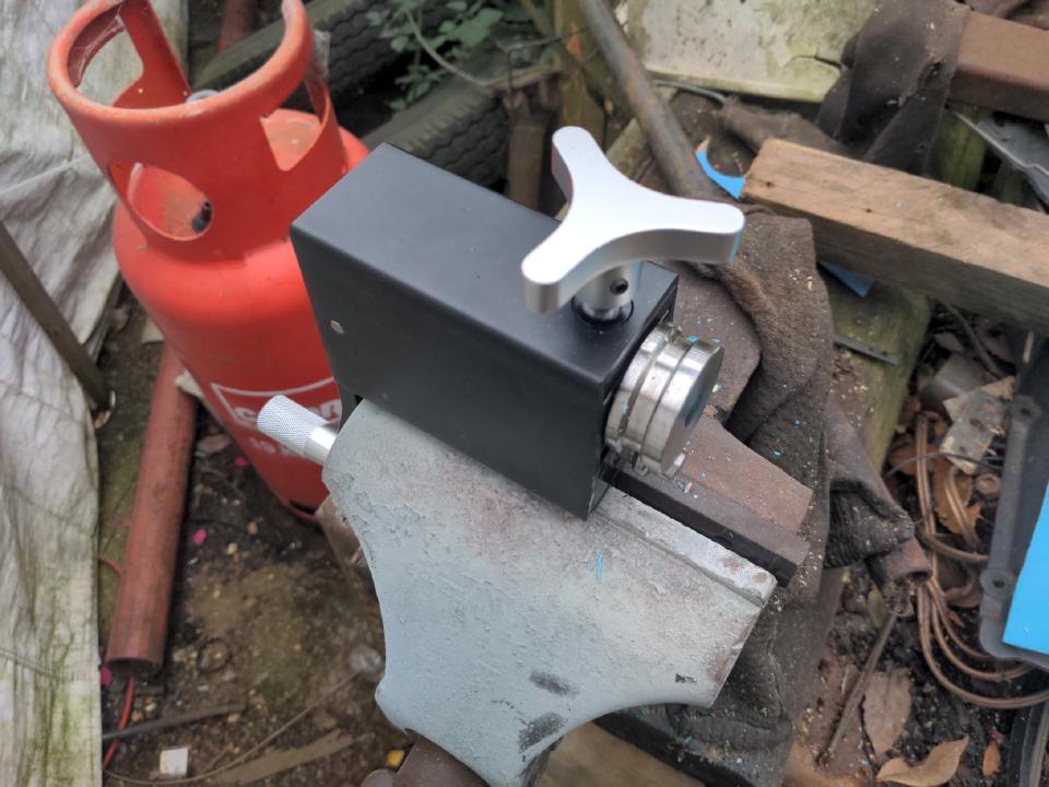 A bead roller. It has two steel rollers on it, one big, one small. The pipe clamps between these two rollers, and a hand crank turns the roller, which presses a bead into a piece of pipe.