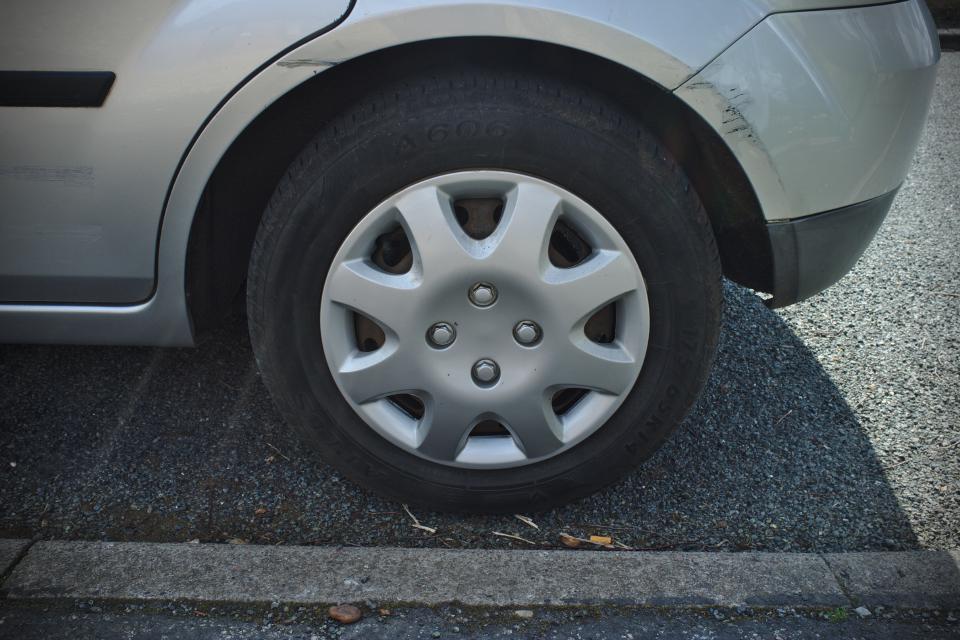 A cheap aftermarket wheel trim on a Ford Fiesta front wheel.