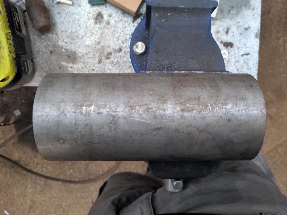 A piece of mild steel tube in my vice. It is about 20cm long and 3 inches in diameter; the wall thickness is 5mm, but you can't see that in the photo.