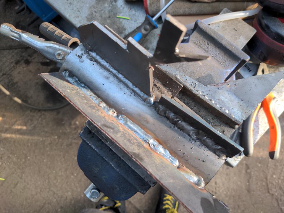 The same piece of tube, but with various little steel plate offcuts welded to it with welds of varying quality.