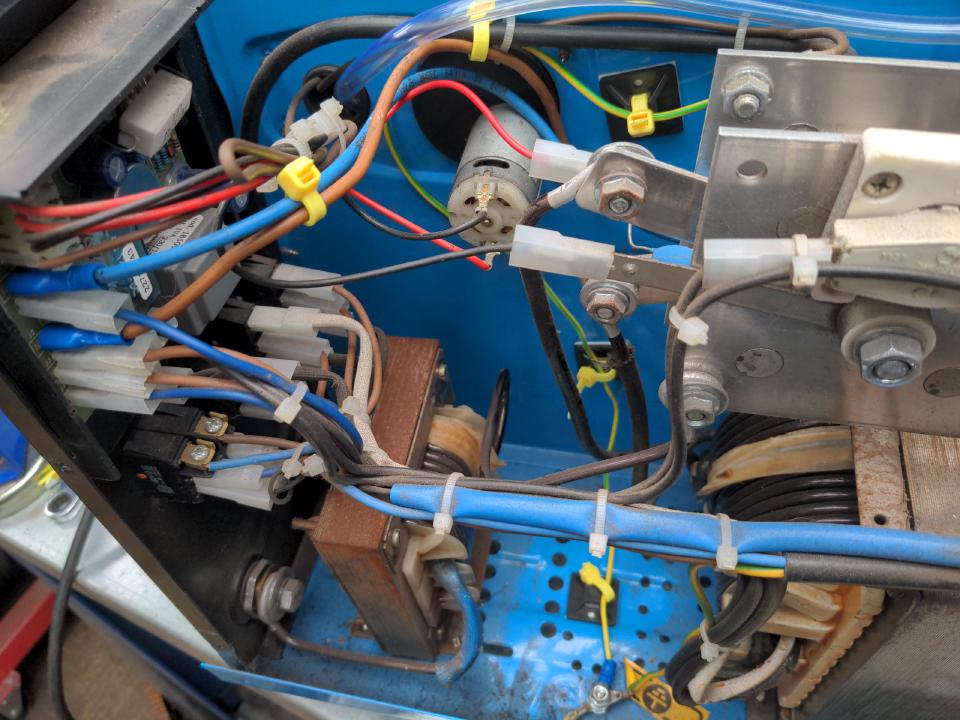 A photo of the inside of the "spicy" side of my welder, showing the routing of the gas feed, and also showing the extra wires I have routed.