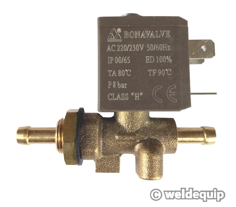 A picture of the Weldequip gas solenoid. It has a brass body with two gas ports, and a box attached above it with three prongs for electrical connections.