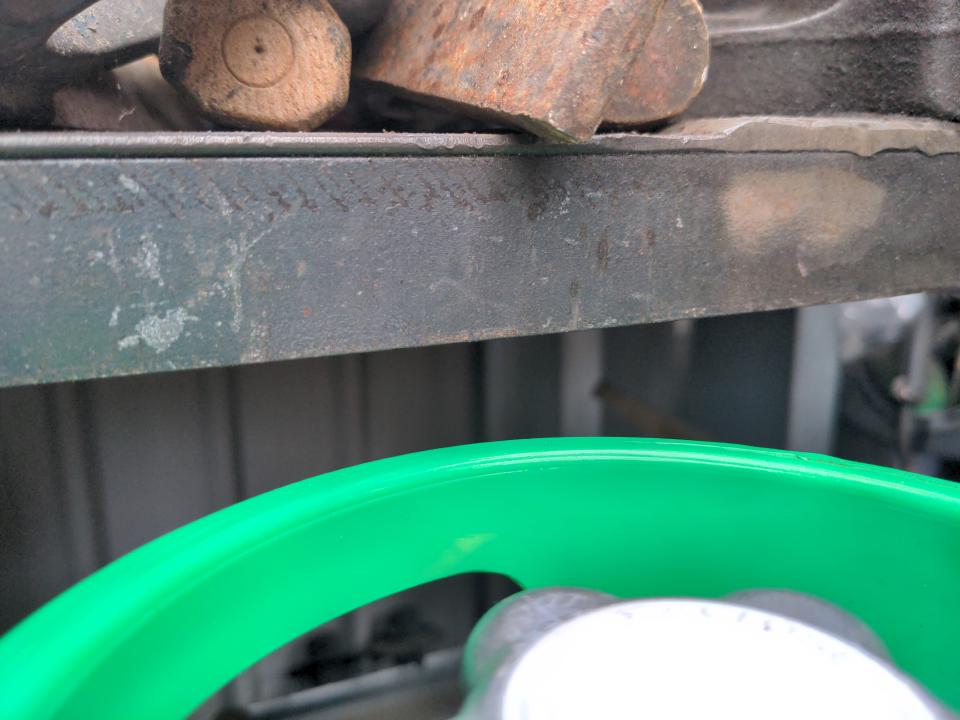 A clearance test. I am sliding my welder under the workbench to see if the top of the gas bottle clears it. It does, by about half an inch.