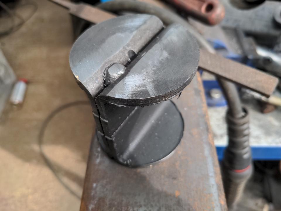 A discarded section from my leaf spring perches. It has been cut out with a hole saw; it is something like two pieces of square C section glued back to back, but the top surface is circular.