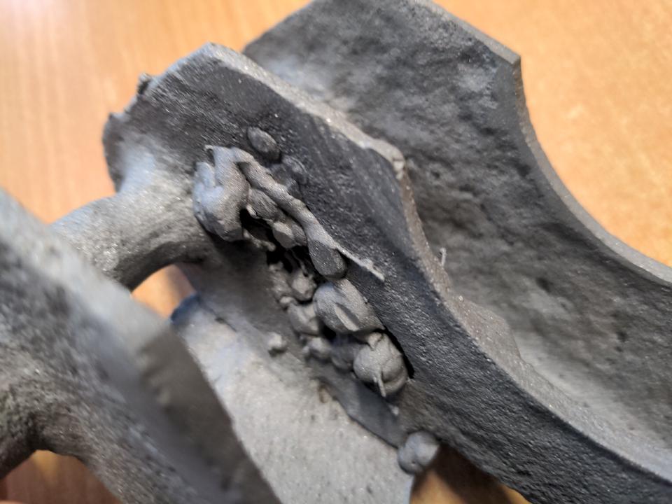 Detail photo of my leaf spring mounts. A crude repair has been made, with blobby, sparse welds that kind of look like they're sitting on the surface. This has created a moisture trap.