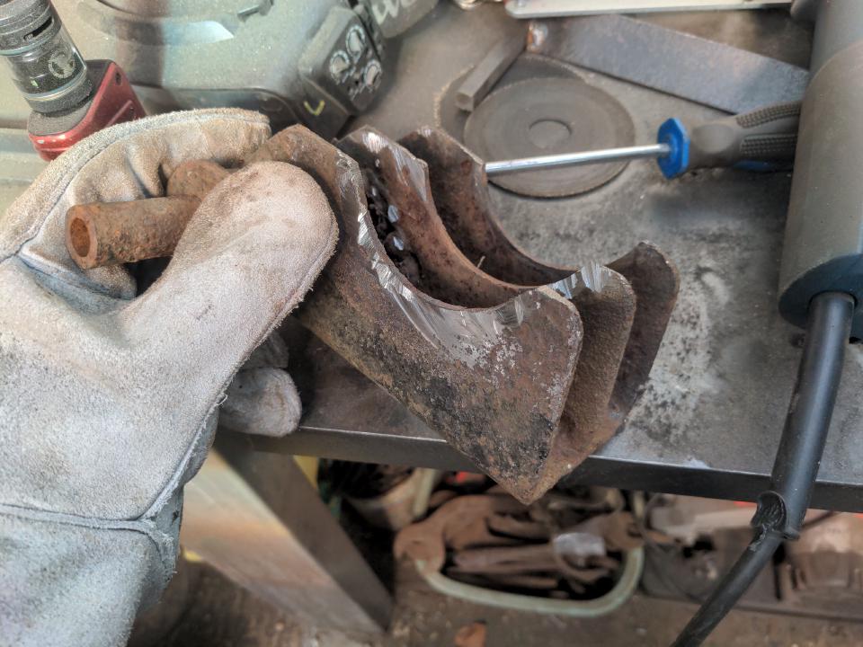 My old leaf spring perch, cut off and in my gloved hand.