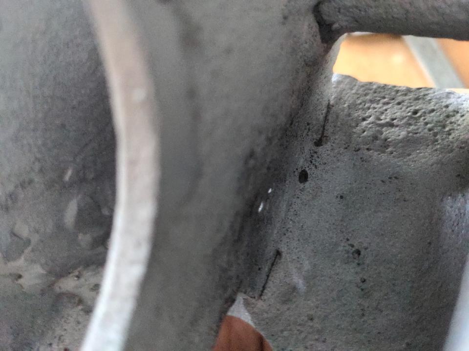 A detail photo of my leaf spring mounts. Where there should be 5mm of solid steel, there is a millimeter or two and there are pinholes in it letting light through.