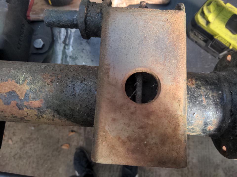 The combined leaf spring seat & shock absorber mount on a Rover P5 axle. It is a steel plate that is welded on to the axle tube spaced from it by about an inch and a bit.