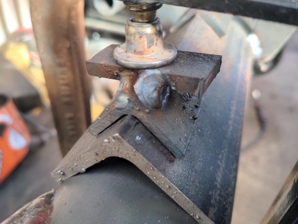 Adapter thingies for allowing a piece of angle iron to be held in place with a G clamp. It is a smaller piece of angle iron, with a flat piece of steel welded on to the apex