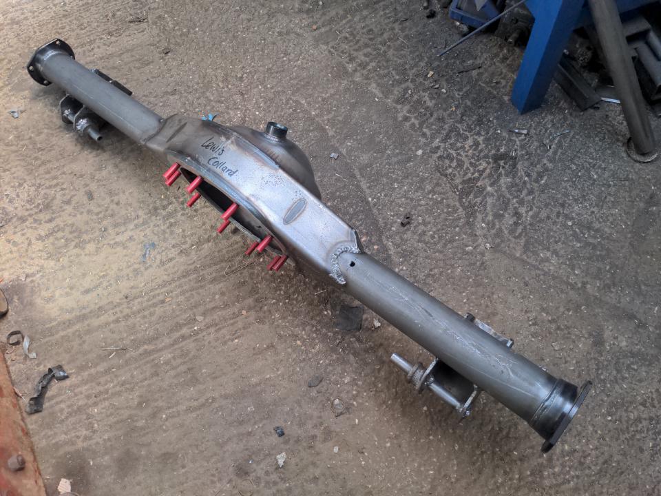 My Ford 9 inch axle housing with both spring perches welded on.