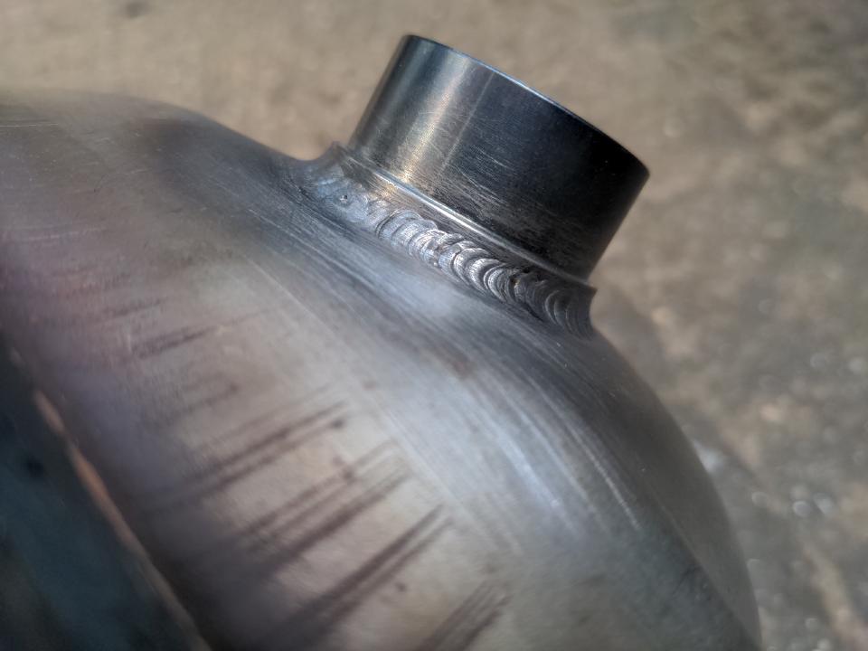 A close up of some very tidy TIG welding at quite a small scale; even though the welds are likely 5mm across the "stacked dimes" effect is strong.