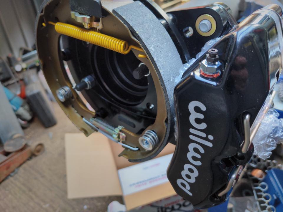 A test fit of my Wilwood calipers and the brackets to my Ford 9 inch axle housing.