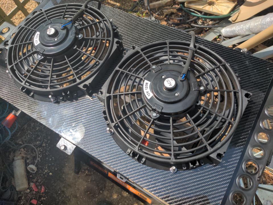 The home-made fan shroud. The carbon fibre weave glistens in the sunlight.