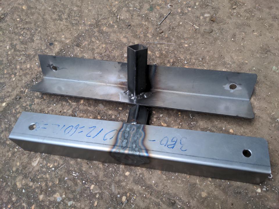 Two of the brackets that will hold my frame for my rear mount radiator to the car. Each one is a length of 50x50x2mm angle iron, about 380mm long. Sticking out of the inside of the angle iron are some short lengths of 1-inch box section, rotated by 45 degrees.