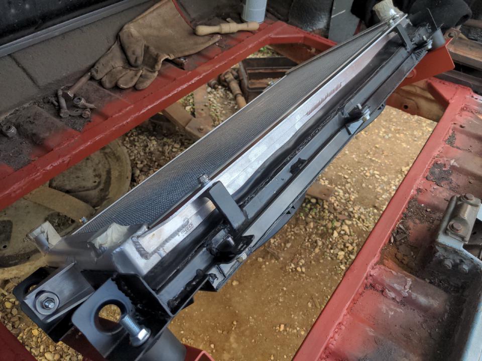 My radiator, its mounting frame, and the fan shroud all mounted into the boot of my Rover P5, finishing the "rear mount a radiator" subproject.