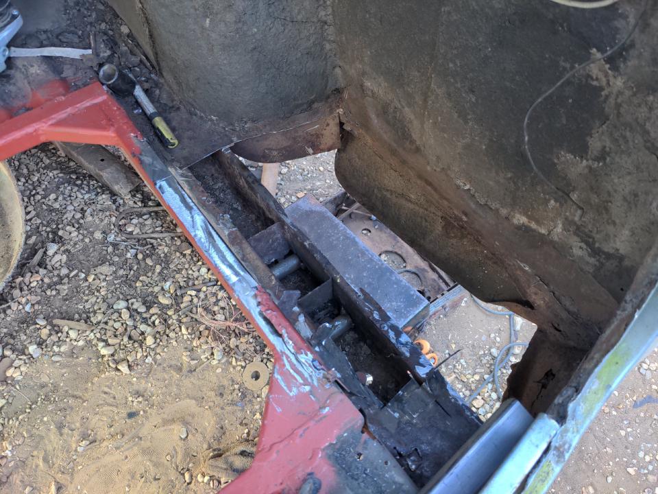 A view behind the rear wheel arch of my Rover P5; almost the entire area has been cut out, leaving a hole about 20cm wide and 40cm long.