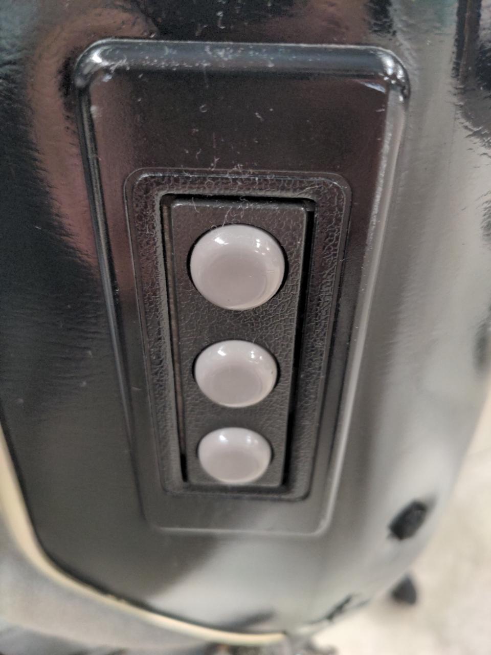 Three grey round plastic buttons.