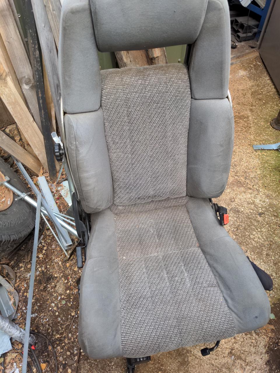 A view of the seat itself again, now attached to a swivel chair base. Some of the worst of the debris has gone, but it is still mildly stained.