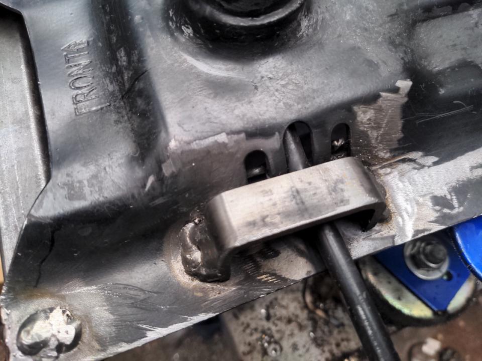 A slice of 50x25x3mm box section steel which has been sliced in half, and then trimmed to make a U-shape. That has been welded on upside down to retain the lever that operates the gas ram on a desk chair; it stops it dropping too far.