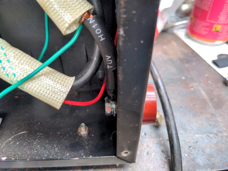 A red Dinse-type socket installed where the earth lead used to come in from the socket.