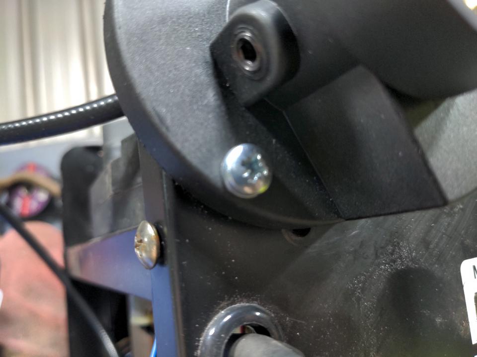 On the underside of the same front connector, a screw hole on the front panel of the welder has been half covered up.