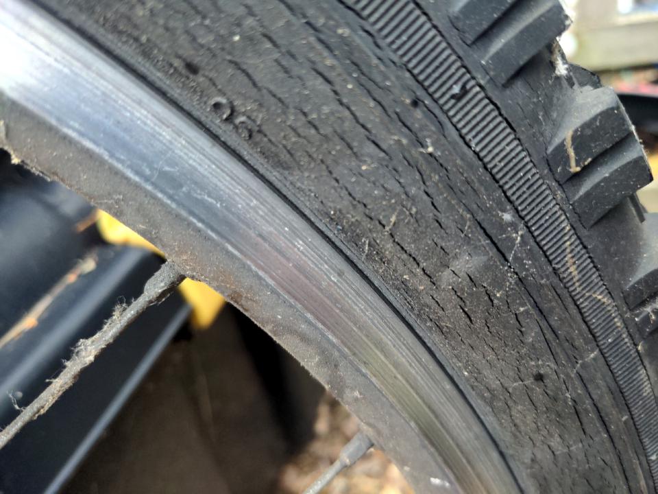 The sidewall of one of the old tyres; a series of hairline cracks are clearly visible.