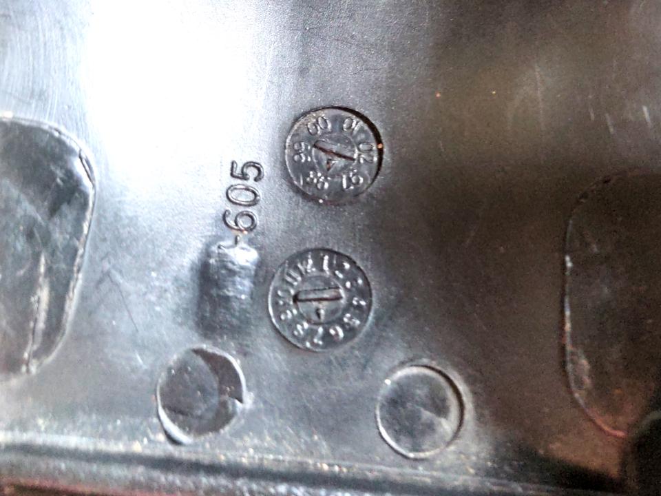 Date stamps on the bottom of an injection-moulded seat. There are two dials printed on it as described, with mine indicating July 98.