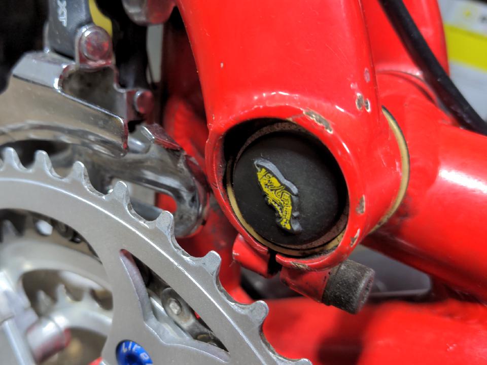 Some more Fred Salmon bar ends, which have been pressed into use as dust caps for the rear suspension pivot of the Proflex frame. These ones are black with a yellow fish.