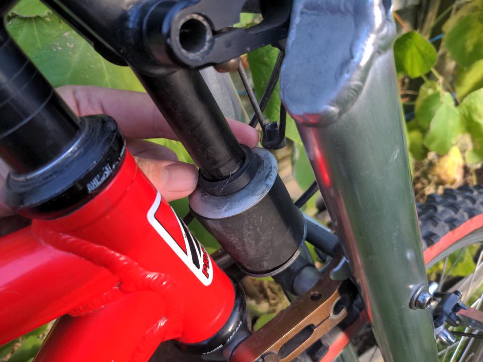 The front elastomer of the Girvin fork; the bottom retainer is at a weird angle indicating a collapse.