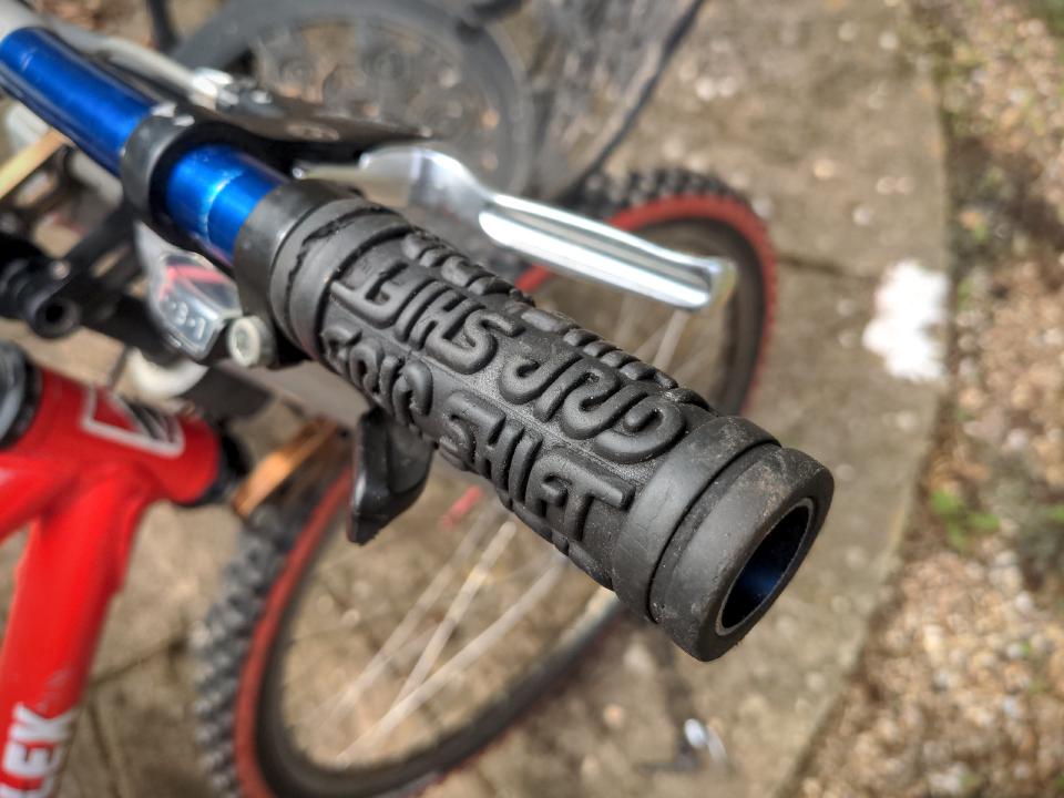 Some handlebar grips, with Grip Shift written on them in deep lettering (forming the anti-slip pattern).