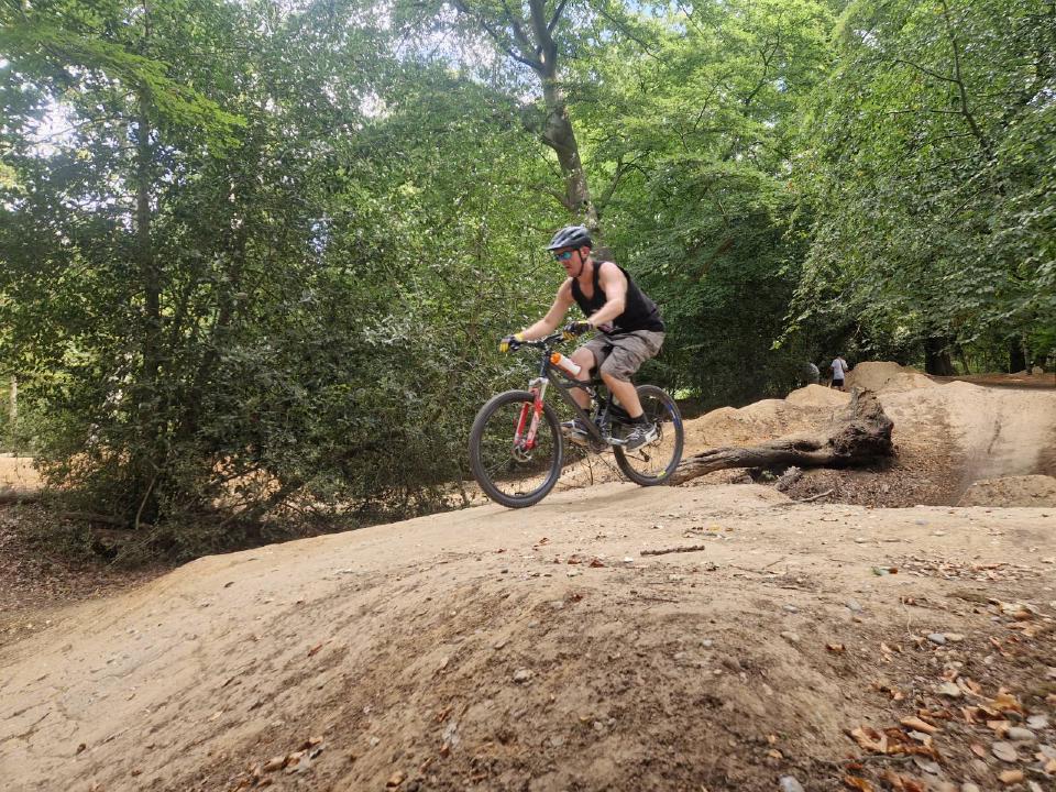Me on the Marin bike in a jump site made by the "trail fairies"; I am not doing a jump but holding on for dear life.