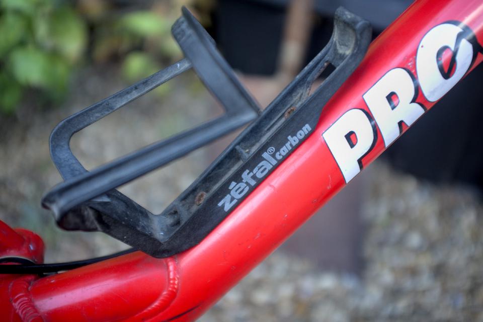The old bottle cage, as described; it is faded black plastic and the heads of the bolts holding it to the frame have rusted heads.