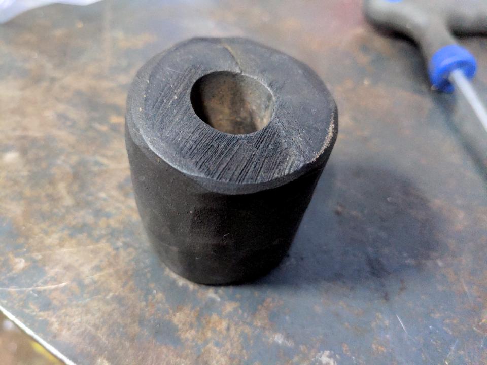 The old "elastomer"; it is clearly a random chunk of rubber that has been hacked up to more or less the same shape (but not size) as the real elastomer.