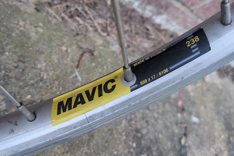 A close up of the yellow and black label on some Mavic 238 rims.