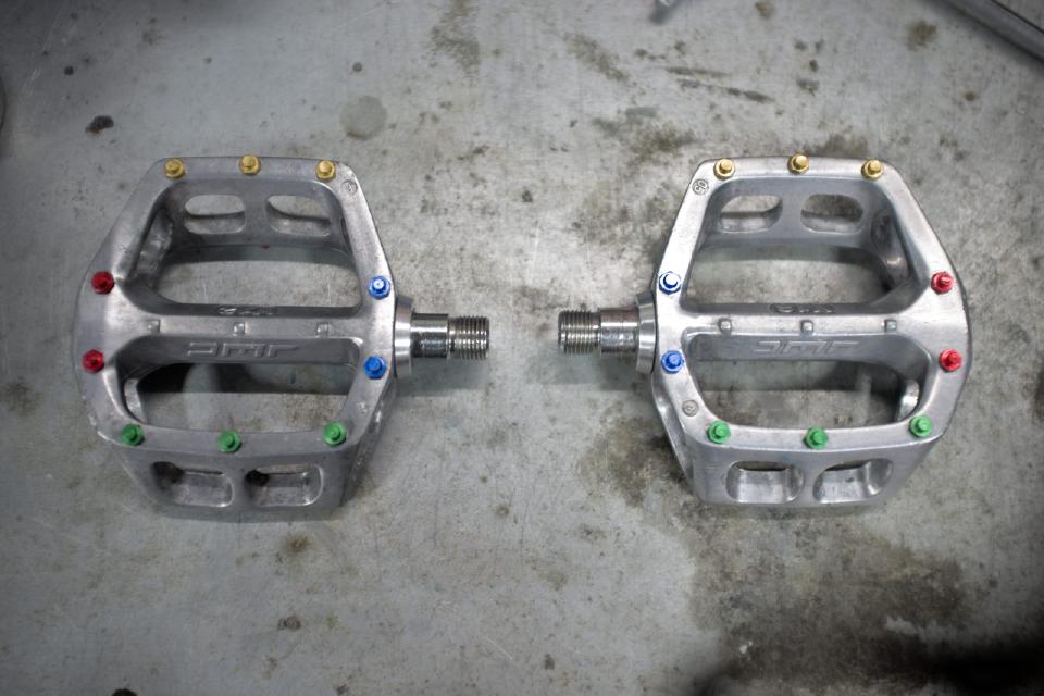 The pedals, reassembled. Yellow, blue, green and red anodised aluminium studs have replaced the rusty steel ones