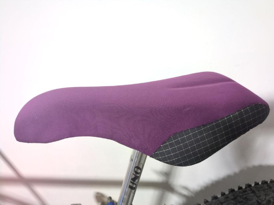 The seat finished, fitted to a bike, with some black Kevlar hybrid fabric glued onto the rear corners.