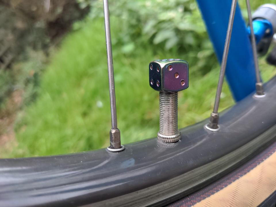 The valve caps on my bike; they are rainbow anodised and they look like dice